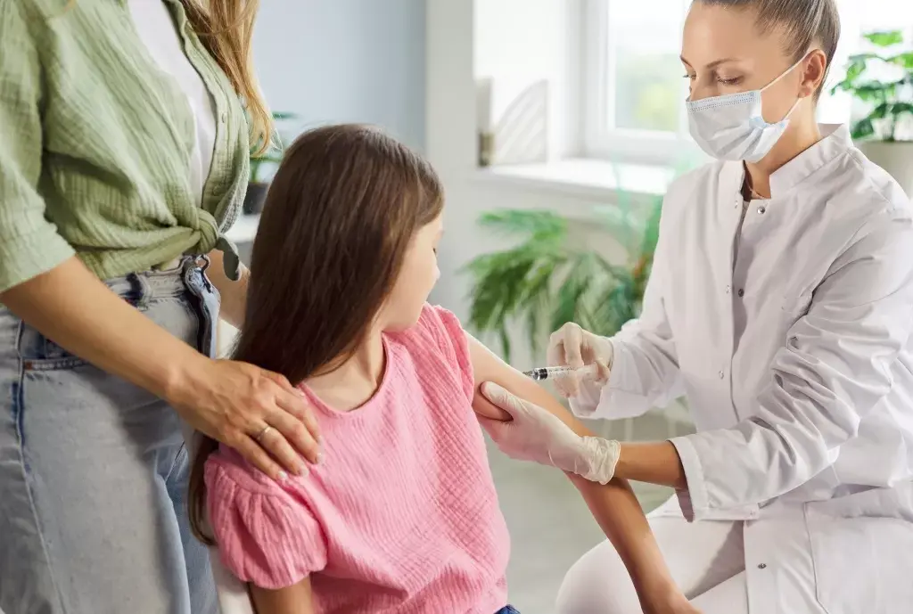 پزشک در حال بررسی دوز واکسن برای یک بیمار بزرگسال
